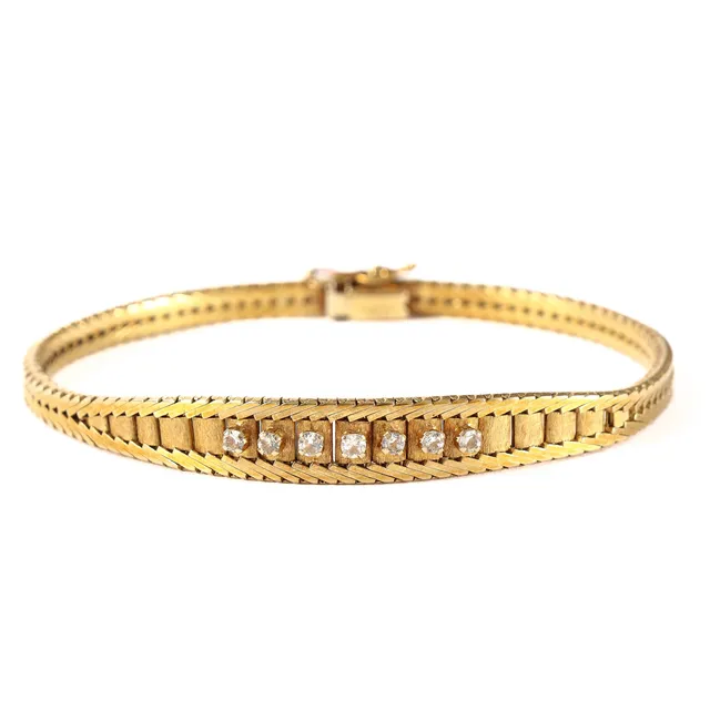 Herman Siersbøl. Vintage herringbone bracelet of 14 kt. gold with seven round-cut clear goshenite stones.