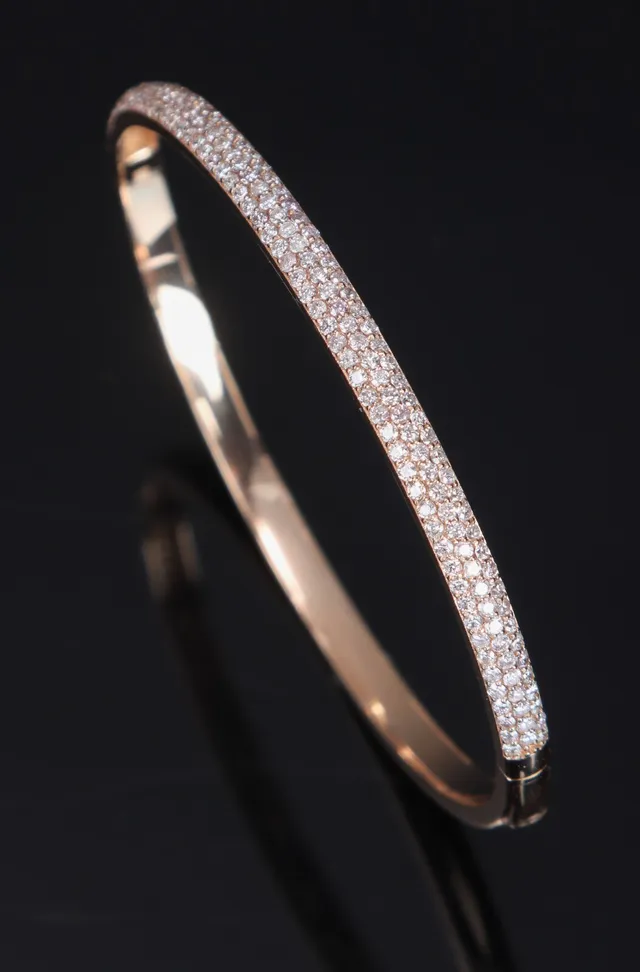 Brilliant bangle, bright pink glasses.