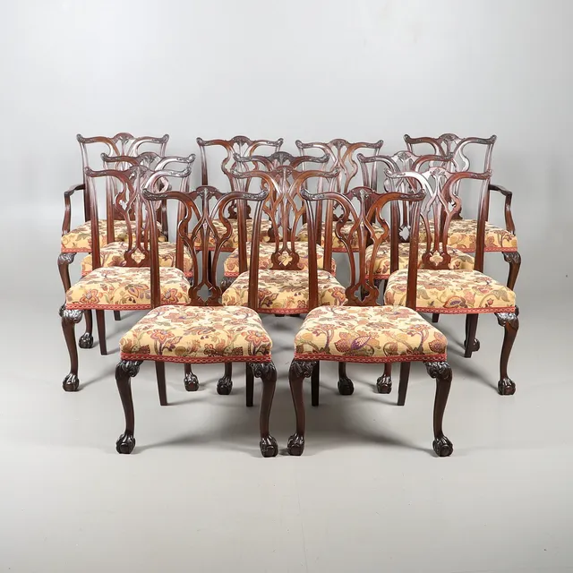 A SET OF TWELVE CHIPPENDALE STYLE MAHOGANY DINING CHAIRS, BEARING GILLOWS & CO STAMP.