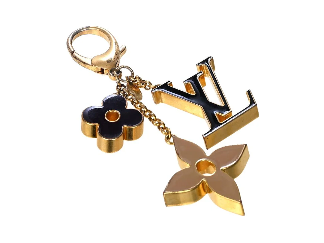 NYCKELRING, LOUIS VUITTON, Fleur De Monogram Bag Charm, guld, svart, beige. — Accessoarer/Nyckelringar — Kaplans