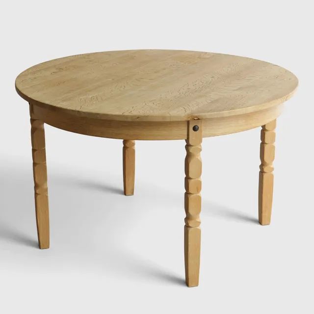Cirkulært spisebord af massiv eg med udtræk, ben med udskæringer. Udført i Danmark, 1960-70'erne - Henry Kjærnulf-stil.