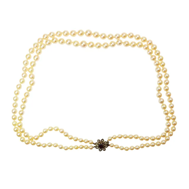 TWO STRAND CULTURED PEARL NECKLACE, 9CT GOLD SEED PEARL AND GARNET CLASP, 58 GRAMS.