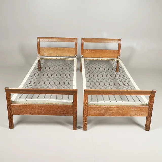 HEALS - PAIR OF LIMED OAK SINGLE BEDS.
