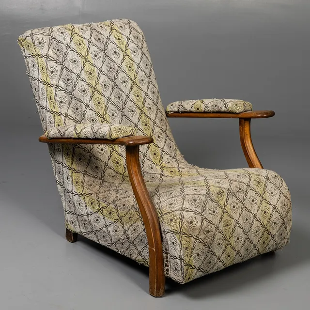 SMALL LOW ARMCHAIR WITH LIGHT WOOD FRAME.