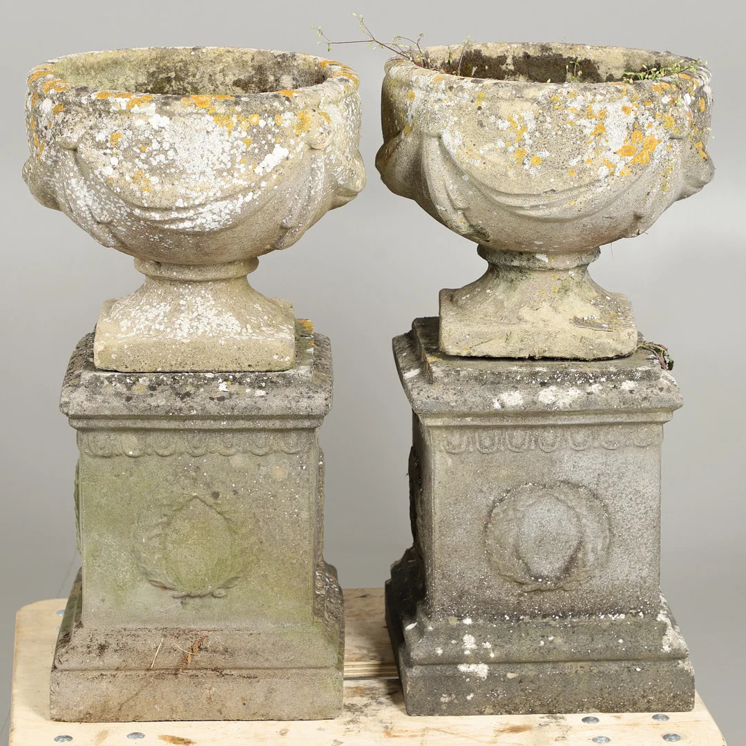 A PAIR OF RECONSTITUTED STONE URN PLANTERS ON PLINTHS. — Garden — Lawrences Auctioneers